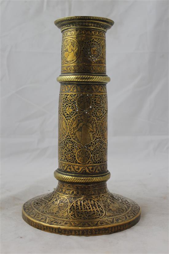 A 19th century Qajar Islamic pierced brass torch stand, 10.5in.